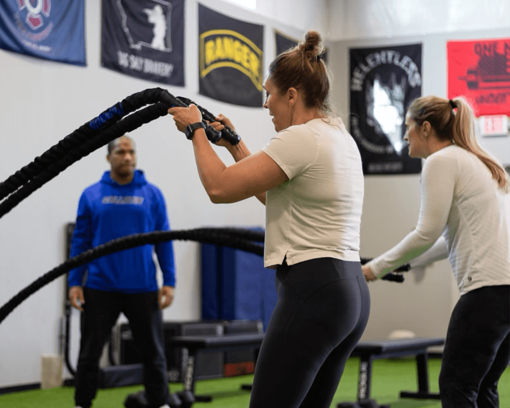 Athletes training with battle ropes inside the lab